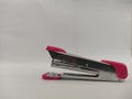 pink stapler isolated on a white background