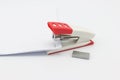 Pink stapler and paper document on white background Royalty Free Stock Photo