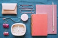 Pink stationery office supply on blue fabric desk background. flat lay, top view