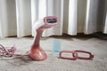 Pink Steamer iron close up. Household appliances photographed for sale. Partial focus Royalty Free Stock Photo