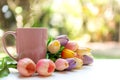 Pink steaming cup of hot coffee on white wooden near window with tulip flowers Royalty Free Stock Photo