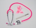 Pink stethophonendoscope, satin ribbon and scalpel on white background. Royalty Free Stock Photo