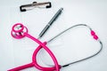 Pink Stethoscope with plastic clipboard , blank paper and pen