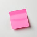 A pink sticky note is affixed to a plain, light-colored surface. The square-shaped note Royalty Free Stock Photo