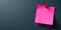 Pink sticky note against a dark gray backdrop, macro, design Royalty Free Stock Photo