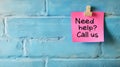 Pink Sticky Note With The Text Need Help Call Us On A Blue Brick Wall, Business Support Concept Royalty Free Stock Photo