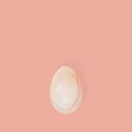 Pink stone Easter egg close up. Minimal style composition with Easter design concept. Monochrome colors background.