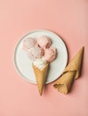 Pink strawberry and coconut ice cream scoops on plate Royalty Free Stock Photo