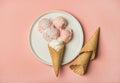 Pink strawberry and coconut ice cream scoops and sweet cones Royalty Free Stock Photo