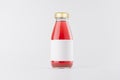 Pink strawberry juice in glass bottle with gold cap and white blank label mock up on white background with copy space, template. Royalty Free Stock Photo