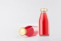 Pink strawberry juices in glass bottles with gold empty cap for label mock up on white background with copy space, template. Royalty Free Stock Photo