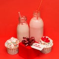 pink strawberry milkshake in bottles cocktail straws, cute cupcakes ,gift box Royalty Free Stock Photo