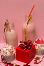 Pink milkshake bottles and cupcakes Royalty Free Stock Photo