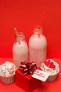 Pink strawberry milkshake in bottles cocktail straws, cute cupcakes ,gift box Royalty Free Stock Photo