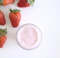 Pink strawberry smoothie and fresh strawberries on a wooden white background .Healthy , yummy beverage in glass. Summer ripe Royalty Free Stock Photo