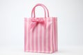Pink striped beach tote with nautical design on white background, ideal for summer fashion