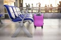 pink suitcase in departure terminal at the airport Royalty Free Stock Photo