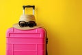 pink suitcase on yellow background, AI generated Royalty Free Stock Photo