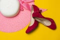 Pink summer women`s hat and red suede shoes lie on a yellow background Royalty Free Stock Photo