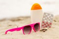 Pink sunglasses, shells, lotion and pills of vitamin A, seasonal concept Royalty Free Stock Photo