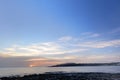 Pink of sunrise on the horizon behind sea at Malta, St. Paul.