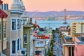 Pink sunrise lighting over residential area of San Francisco with Oakland Bay Bridge and view of bay Royalty Free Stock Photo