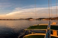 Pink sunrise over the sea and Naoussa coastal village Paros Island, landscape view from sailing boat with boat canopy, Greece Royalty Free Stock Photo