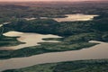 Pink sunrise sunlight over a lakes and green mountain valley. Royalty Free Stock Photo