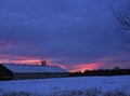 Pink Sunset behind dairy barn in upstate NY during blue hour and supermoon rising Royalty Free Stock Photo