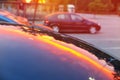 Pink sunset mirrored reflection on a metal car capot Royalty Free Stock Photo