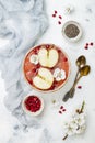 Pink superfoods smoothie bowl with chia seeds, pomegranate, sliced apples and honey. Overhead, top view, flat lay, copy space. Royalty Free Stock Photo