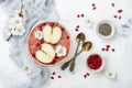 Pink superfoods smoothie bowl with chia seeds, pomegranate, sliced apples and honey. Overhead, top view, flat lay, copy space. Royalty Free Stock Photo