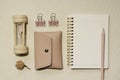 Pink supplies. Sandglass, pouch, clip, notebook, colored pencil on desk. flat lay, top view