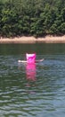 Pink swimming mattress in lake