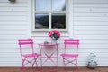 Pink table with two chairs on a terrace in Husoy, little village on a tiny island belonging to the large island of Senja and being