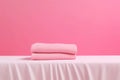 A pink table with two folded towels on it Royalty Free Stock Photo