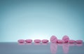 Pink tablets pills with shadow on gradient background. Pharmaceutical industry. Pharmacy products. Vitamins and supplements.
