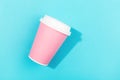 Pink take out cup on aqua color background