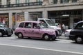 Pink Taxi in London Traffic Road, England