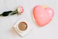 Pink tea rose with heart shaped pink mousse cake with a cup of coffee. Royalty Free Stock Photo