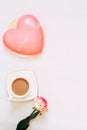 Pink tea rose with heart shaped pink mousse cake with a cup of coffee. Royalty Free Stock Photo