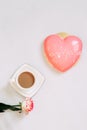 Pink tea rose with heart shaped pink mousse cake with a cup of coffee. Royalty Free Stock Photo