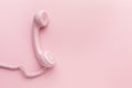Pink telephone receiver on pink background Royalty Free Stock Photo