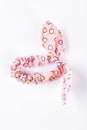 Pink textile patterned hair scrunchy.