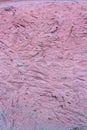 Pink texture of a stone wall from a mortar with recesses. Royalty Free Stock Photo