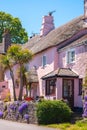 Pink Thatched house on a summer\'s day