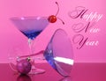 Pink theme Happy New Year party with vintage blue martini cocktail glass and New Years eve decorations Royalty Free Stock Photo