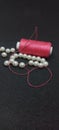 pink thread, needle and beads Royalty Free Stock Photo