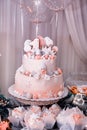 Pink three-tiered birthday cake with caramel decorations