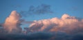 Pink tinged cumulo-nimbus clouds at sunset